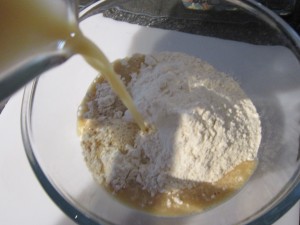 Pouring yeast mixture into the flour