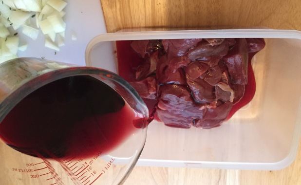 Adding wine, water, and vinegar to marinade